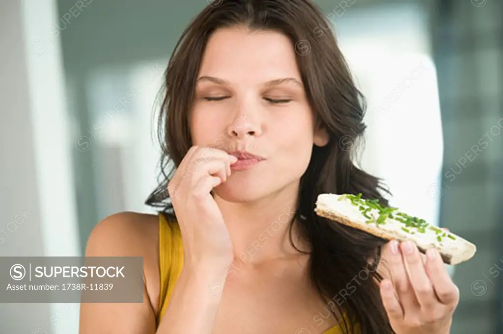 Close-up of a woman eating a bread