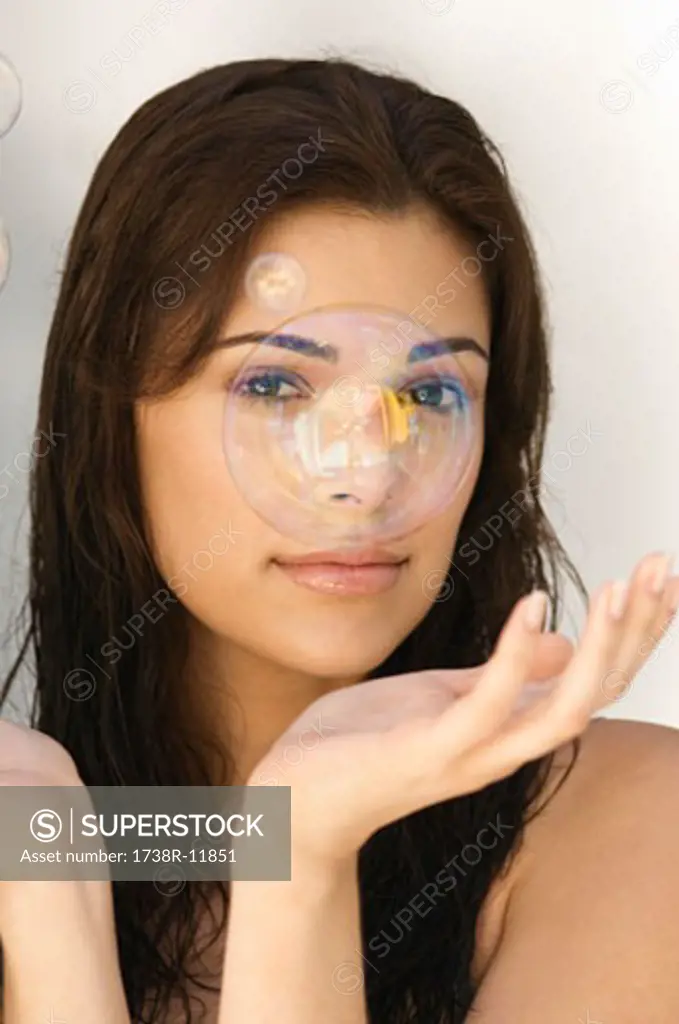 Soap bubble in front of a woman's face