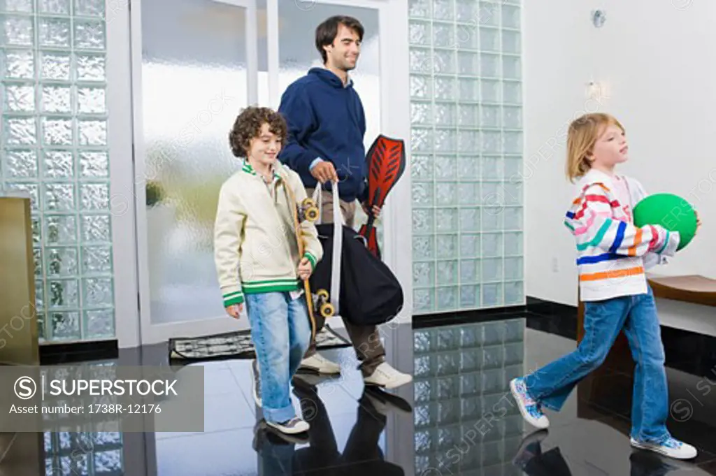 Man entering the house with his children