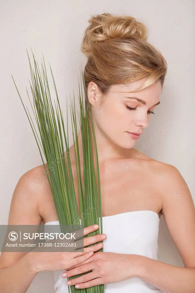 Beautiful woman holding wheatgrass