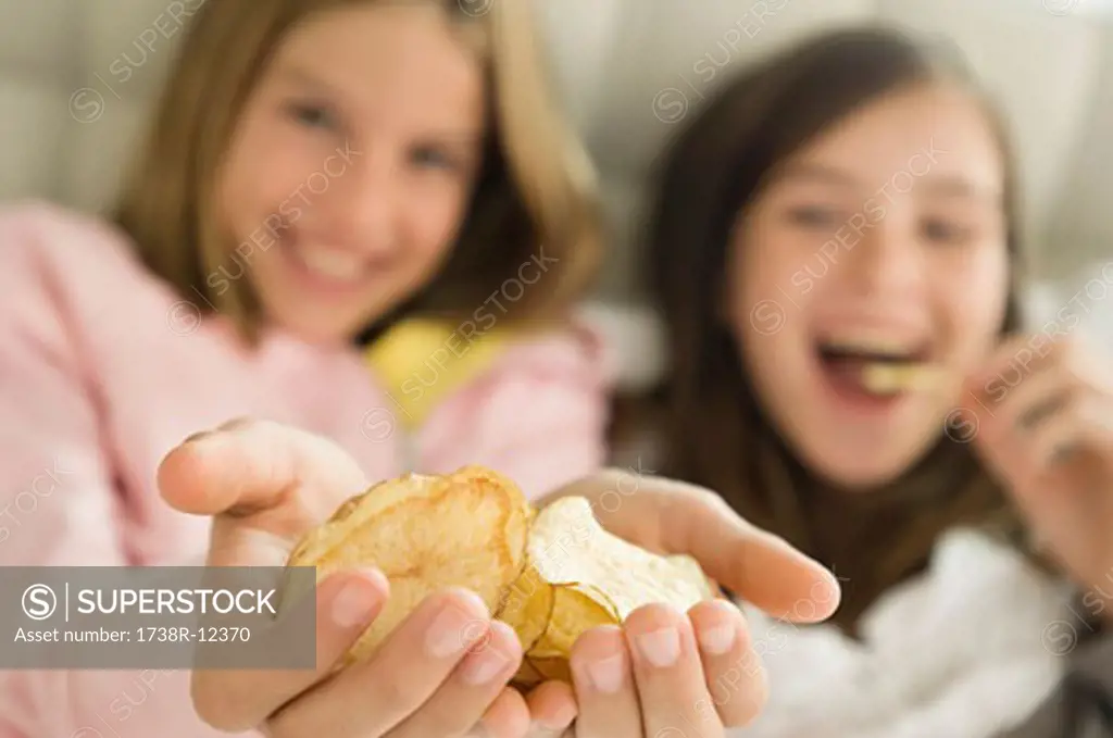 Girl holding potato chips in her hands