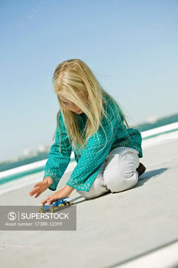 Girl playing with a remote controlled car