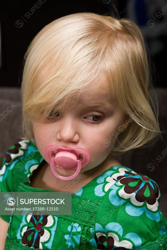 Close-up of a girl sucking a pacifier