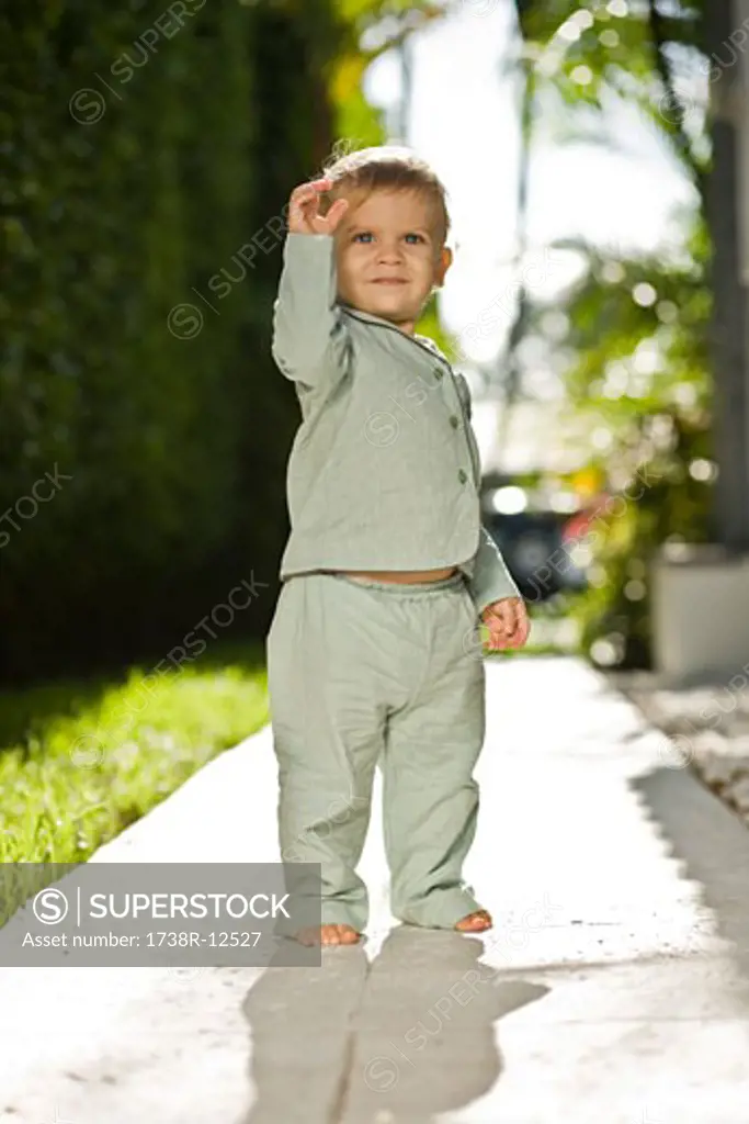 Baby boy standing on a walkway