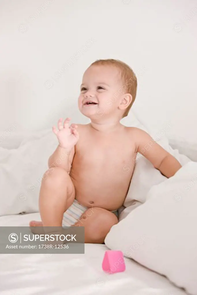 Baby girl laughing on the bed
