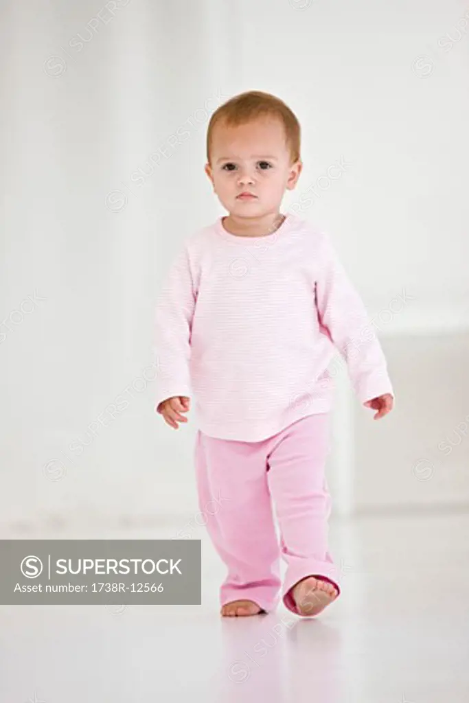 Baby girl walking on the floor