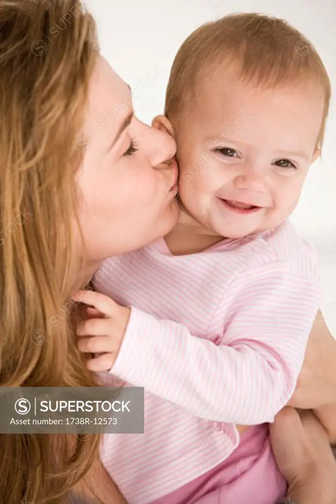 Woman kissing her daughter