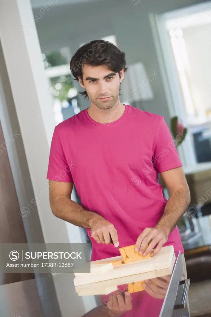 Man cutting cheese slices