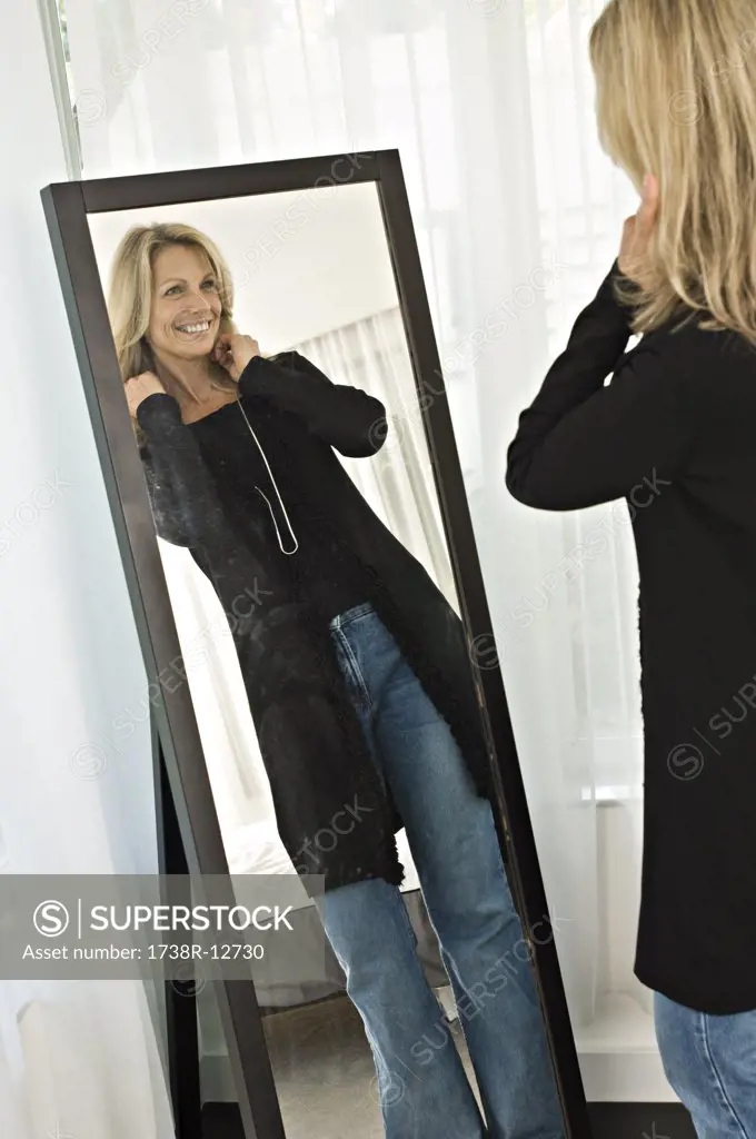 Woman trying on a dress in front of a mirror