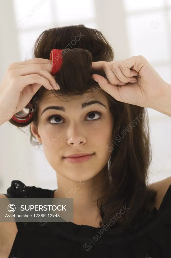 Close-up of a woman removing hair curlers