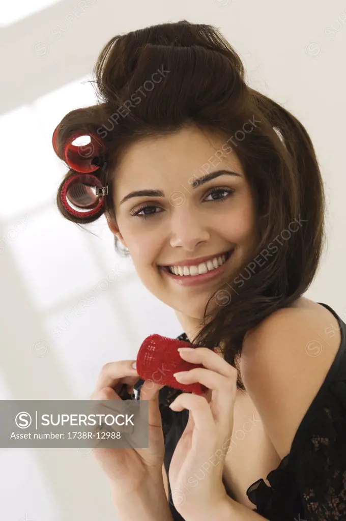 Portrait of a woman removing hair curlers