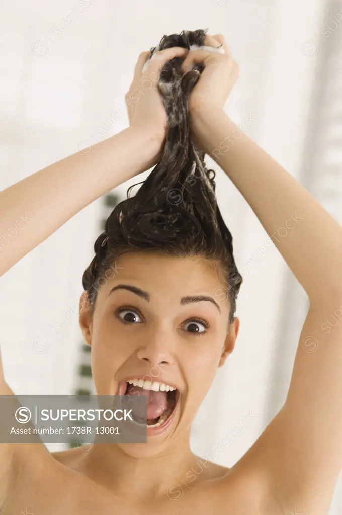 Portrait of a woman shampooing her hair