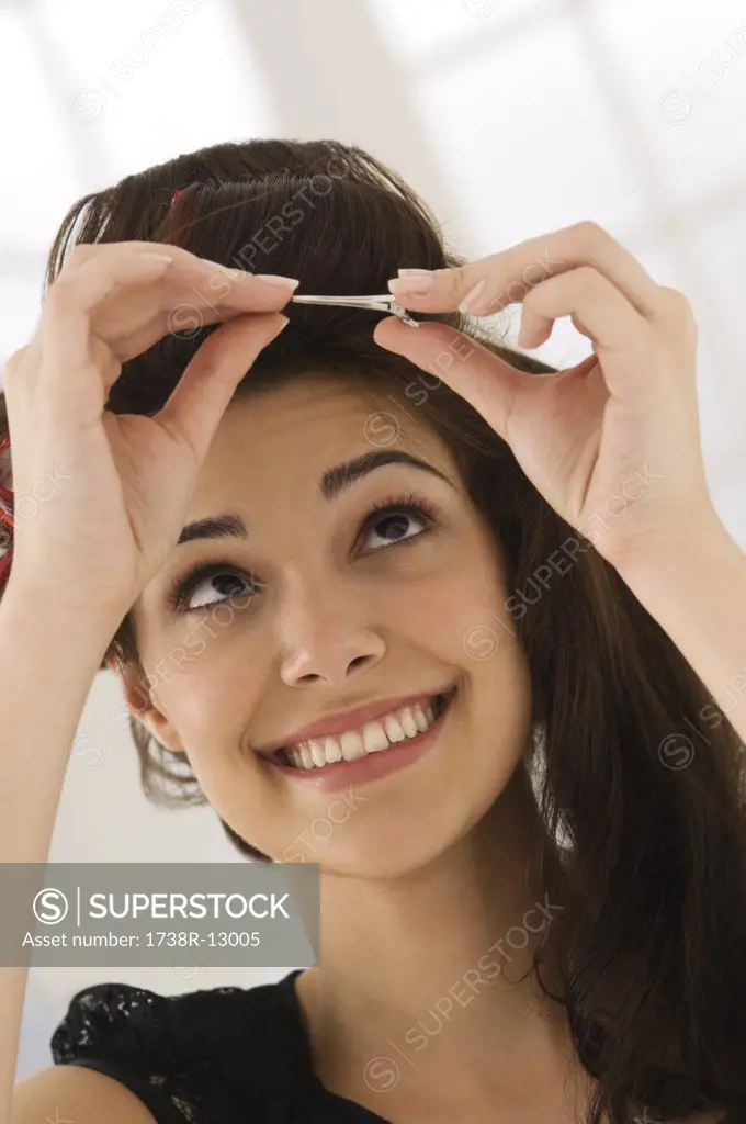 Close-up of a woman removing hair curlers
