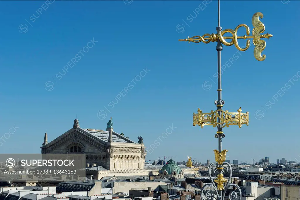 France. Paris 9th district. Weather vane of the terrace of the department store Au Printemps. Background: the Garnier Opera