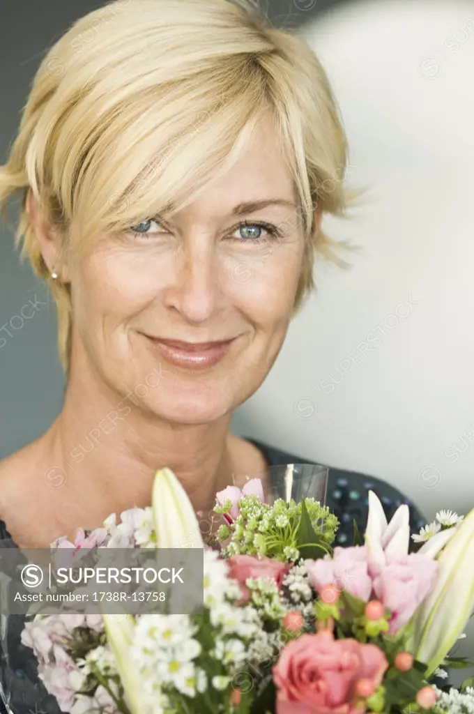 Portrait of a woman smiling with a bouquet of flowers
