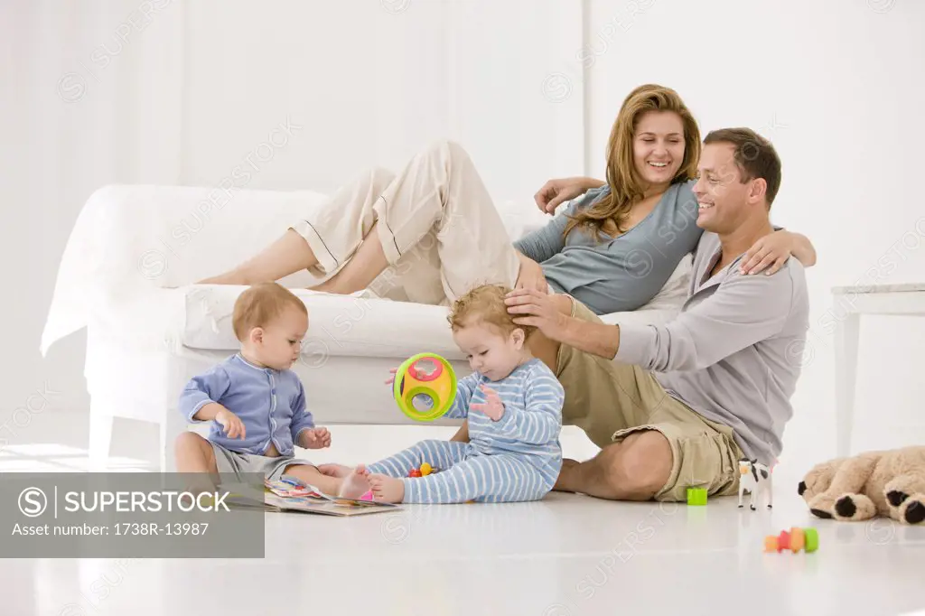 Parents with their son and a daughter in a living room