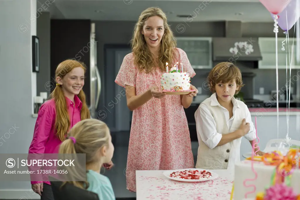 Woman with three children at a birthday party
