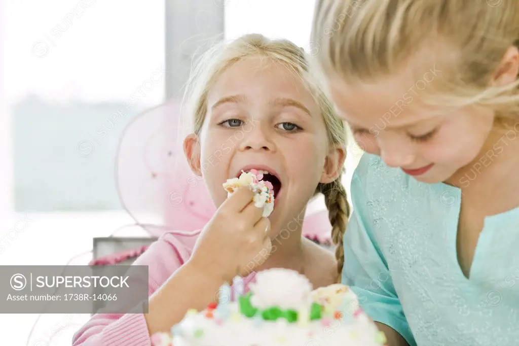 Close-up of a girl eating birthday cake