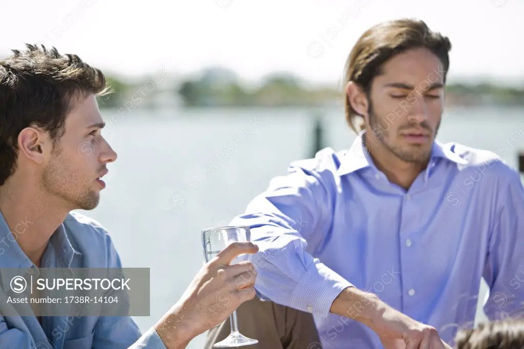 Man enjoying drink with his friend
