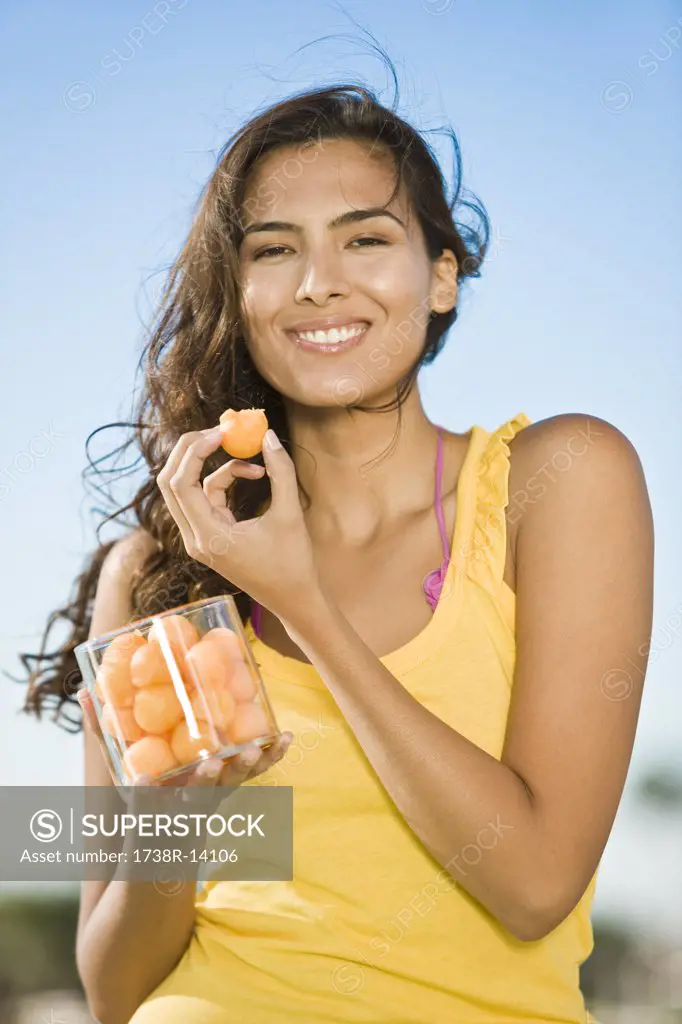 Woman holding a jar of fruits