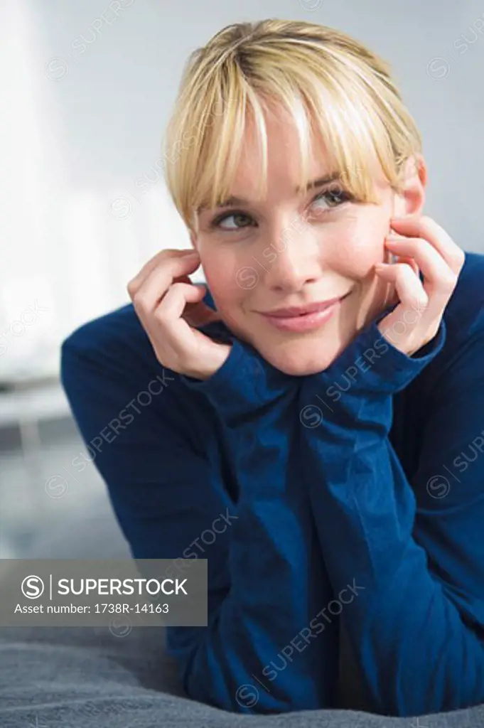 Woman lying on the bed and smiling