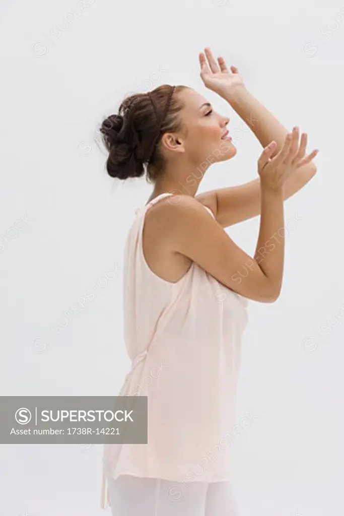 Fashion model posing with her arms raised