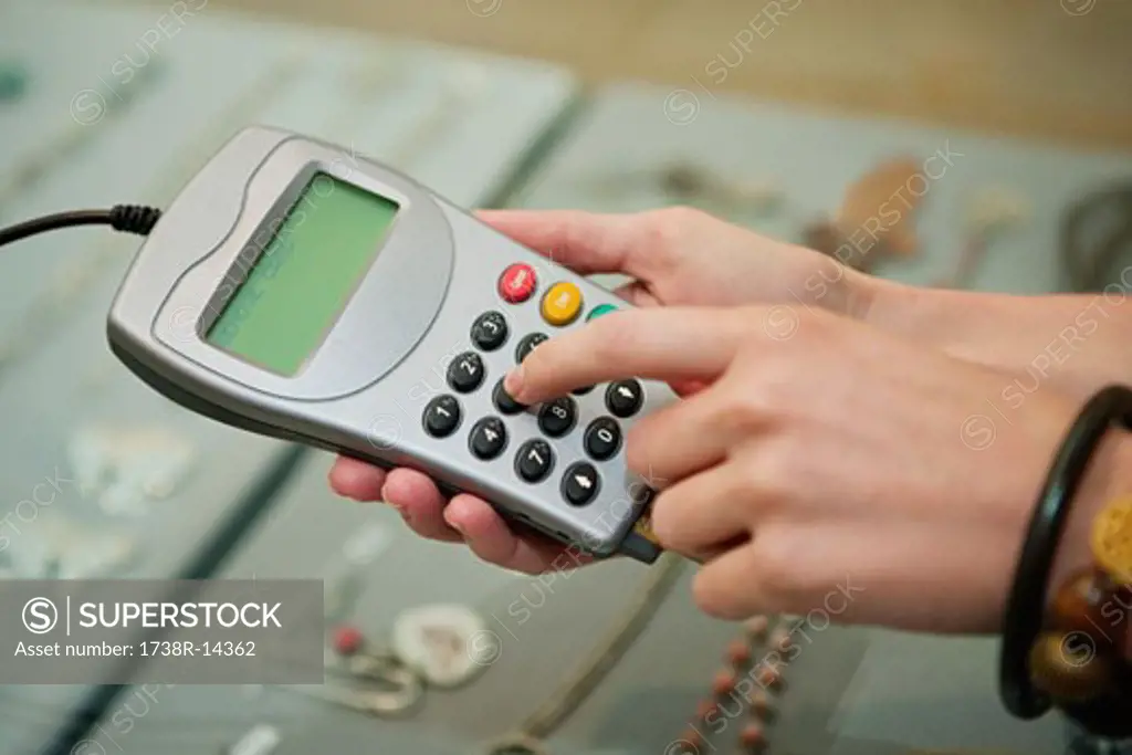 Customer using credit card reader in a boutique