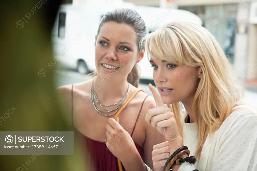 Two women window shopping in a boutique