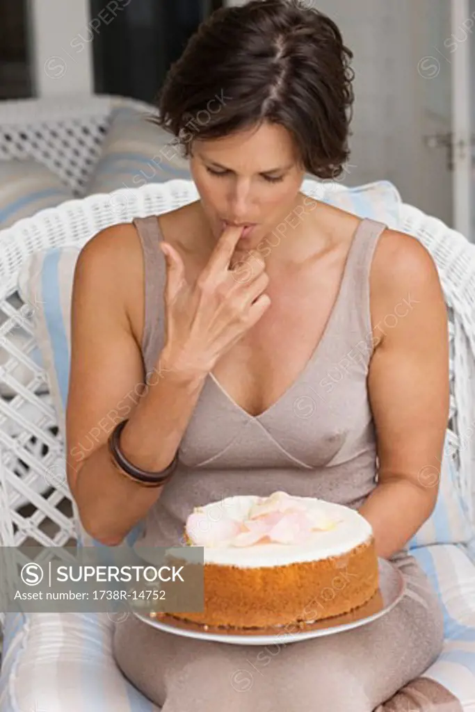 Woman tasting a cake