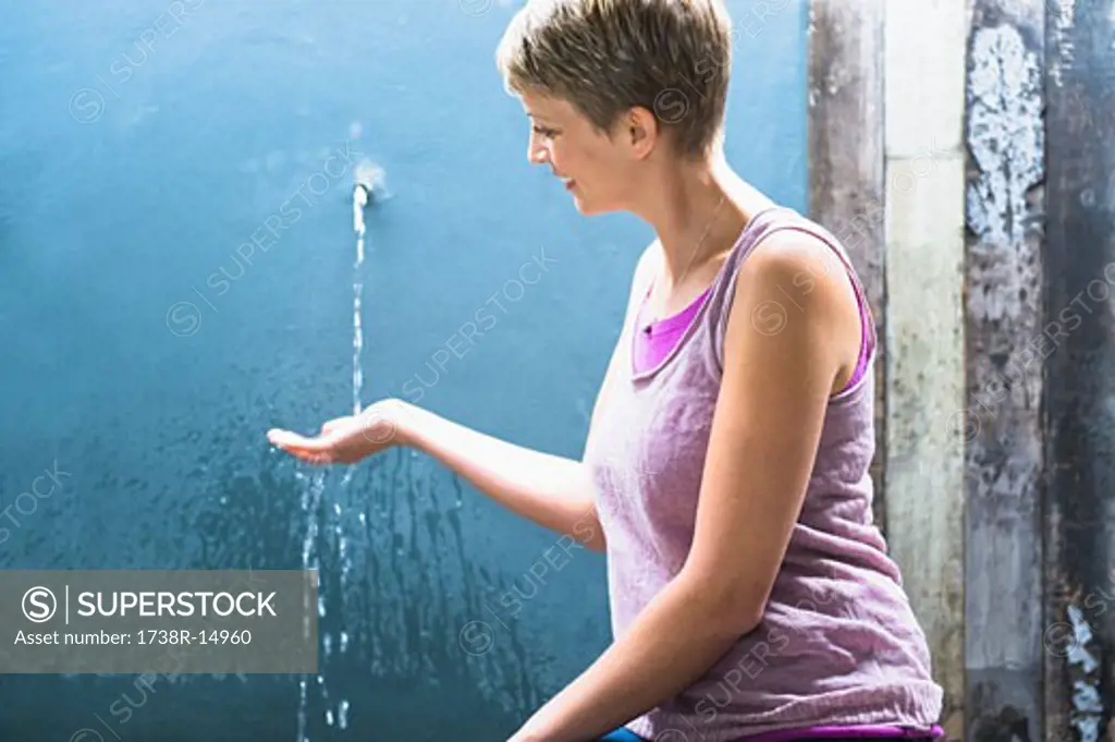 Woman washing hands and smiling