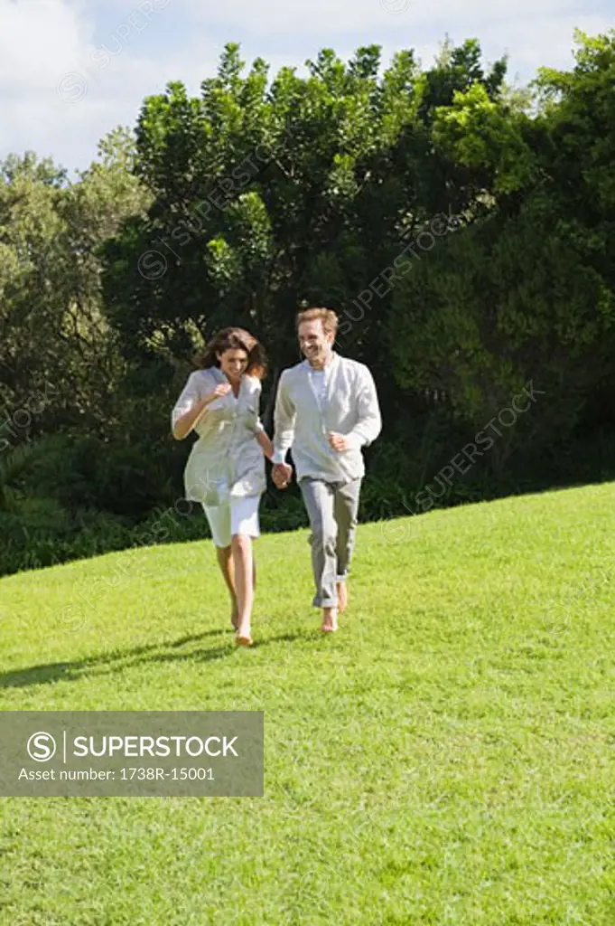 Couple running on grass