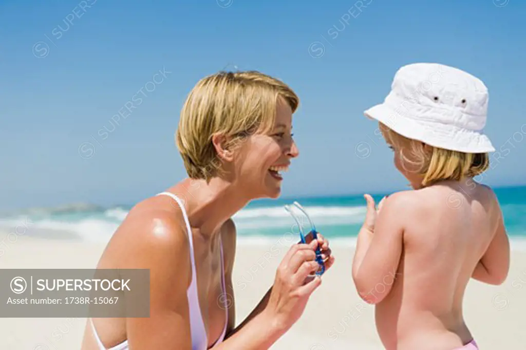Woman having fun with her daughter on the beach