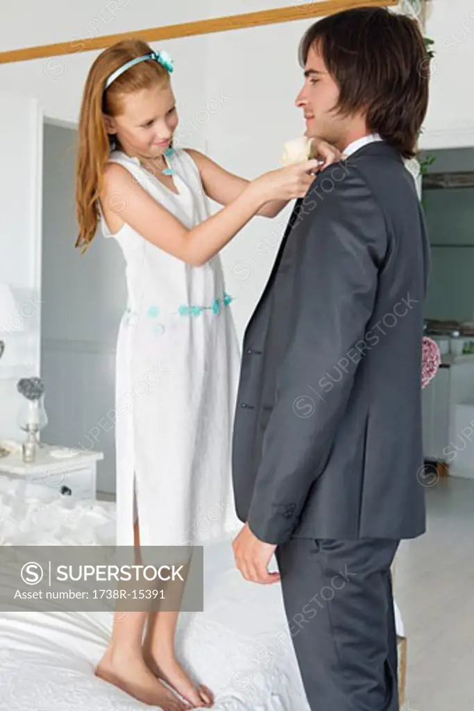 Girl adjusting groom's tie