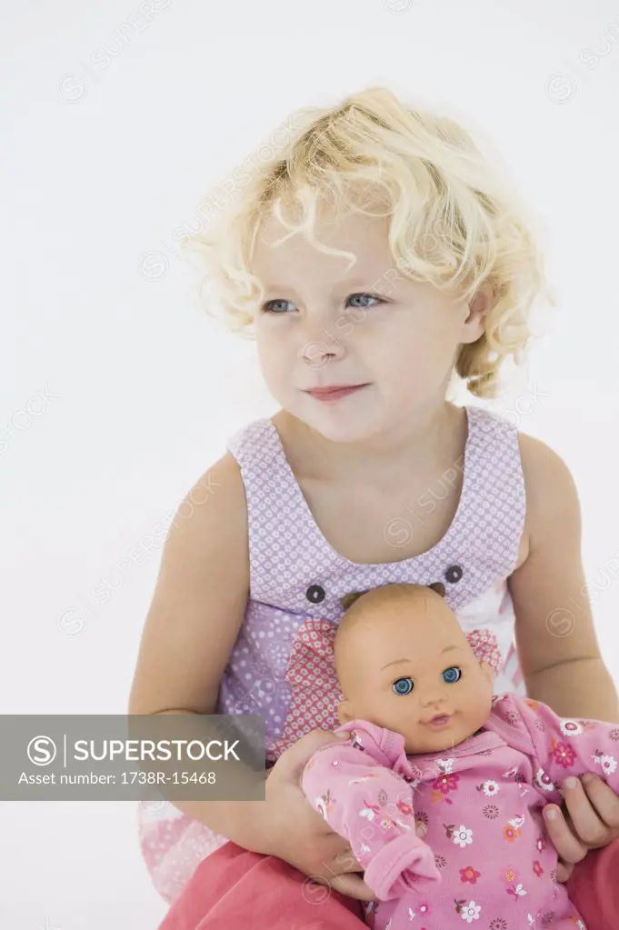 Girl holding a doll