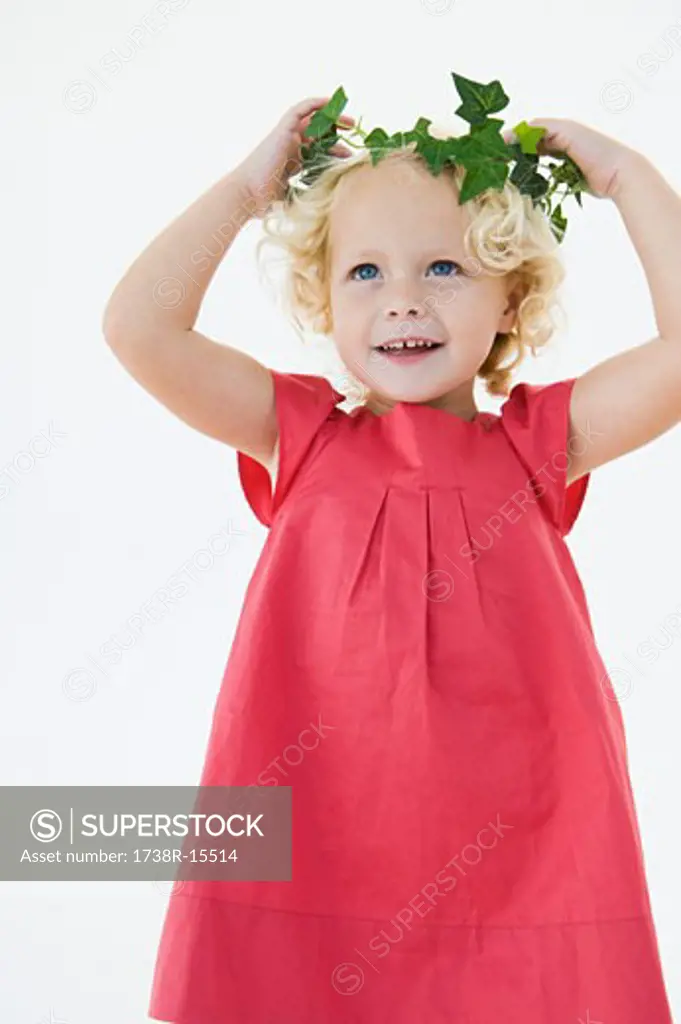 Girl wearing a wreath and smiling