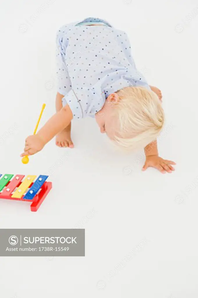 Baby boy playing with a xylophone