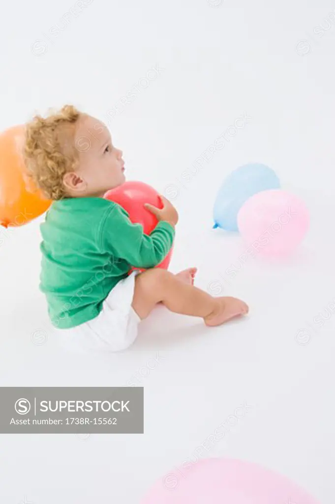 Baby boy playing with a balloon
