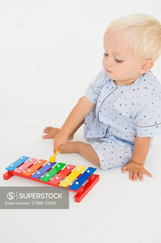 Baby boy playing with a xylophone