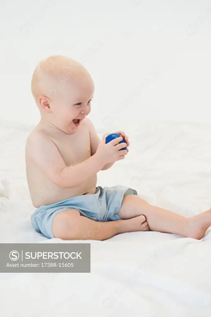 Baby boy playing with a ball