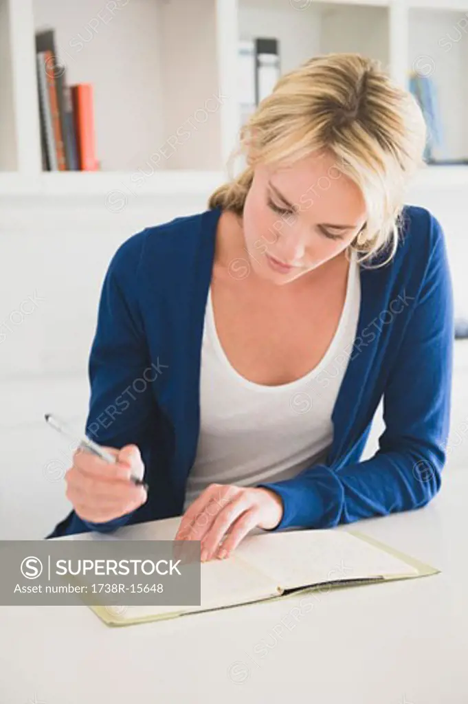 Businesswoman writing on a notepad