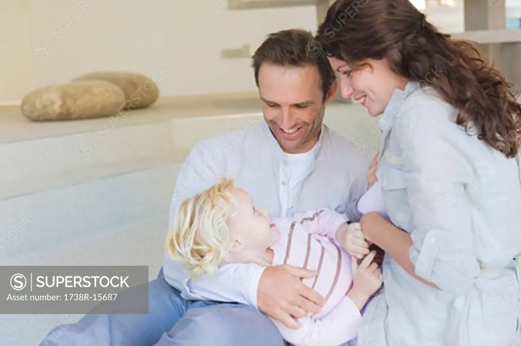 Girl playing with her parents