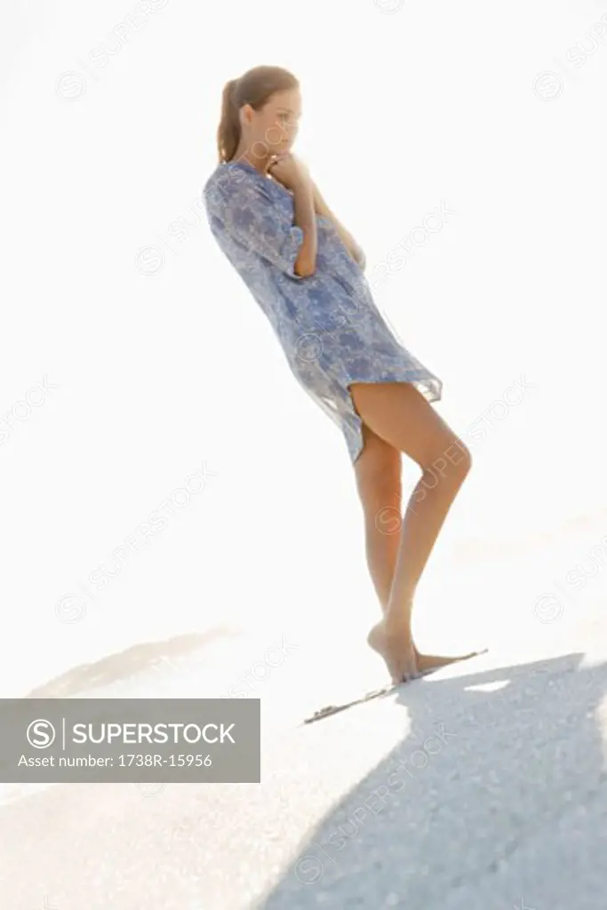 Woman standing on the beach and thinking
