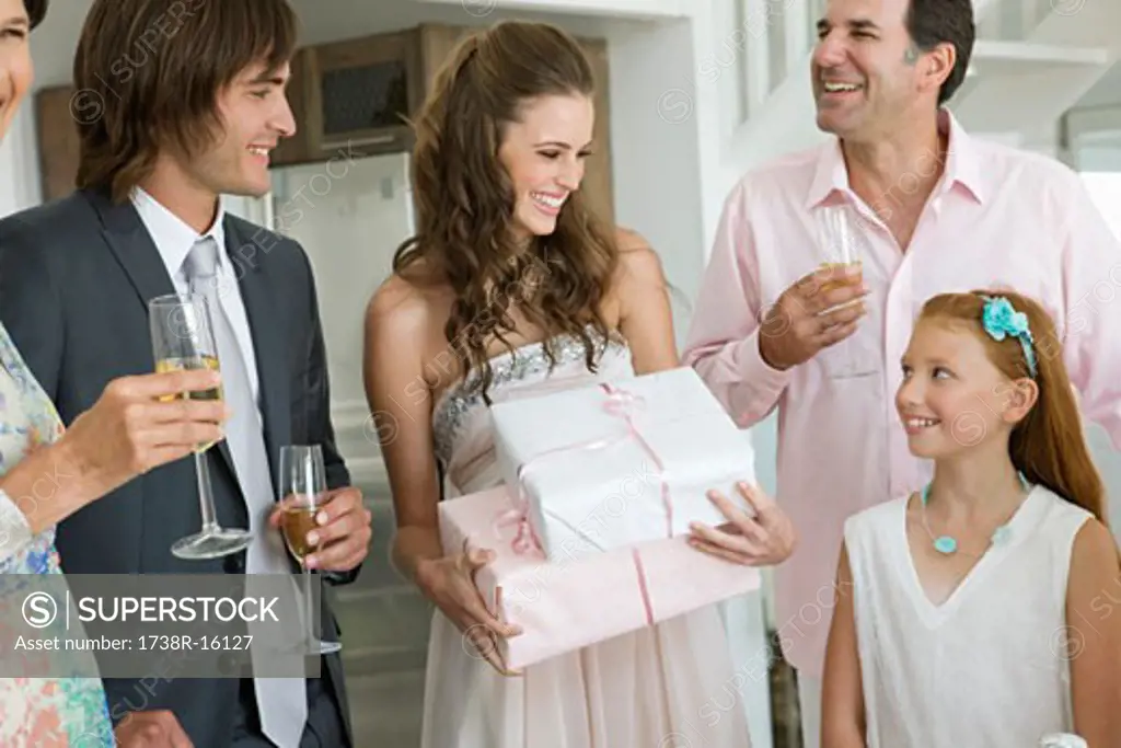 Bride receiving gifts from guests in a party