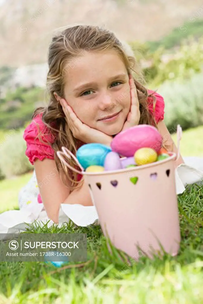 Container of Easter eggs in front of a girl