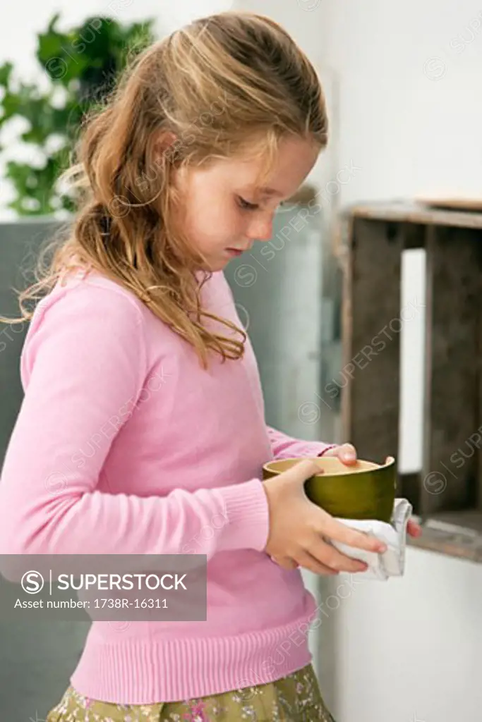 Girl holding a bowl of food
