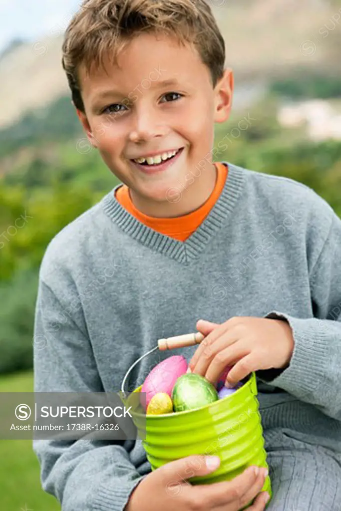 Boy holding a container full of Easter eggs