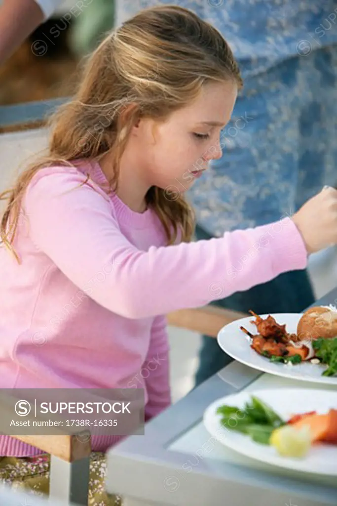 Girl having breakfast at a dining table