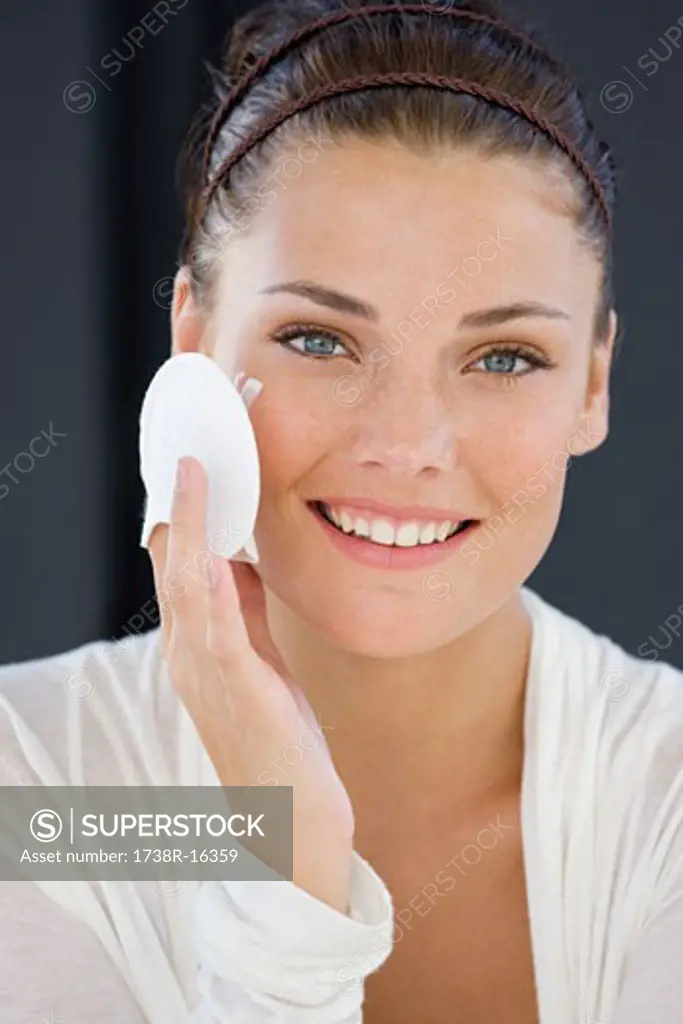 Portrait of a woman applying face powder