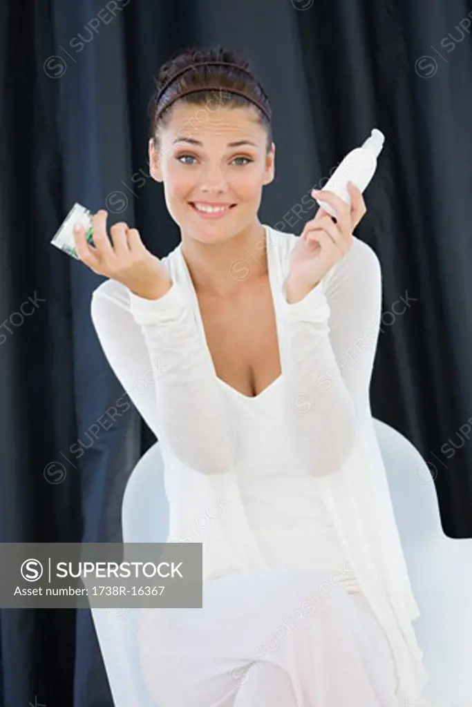 Woman holding cosmetic products