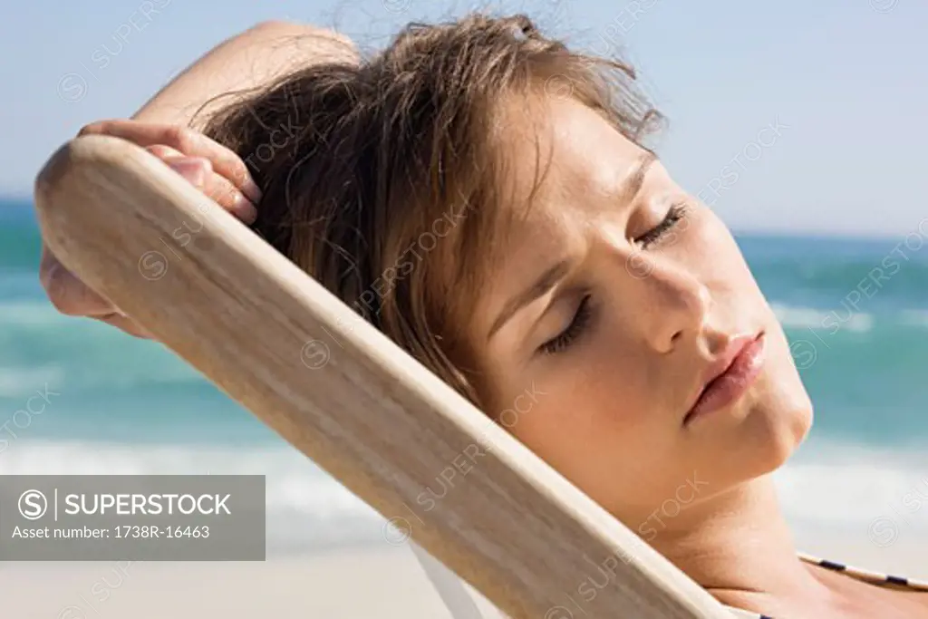 Close-up of a woman resting in a deck chair